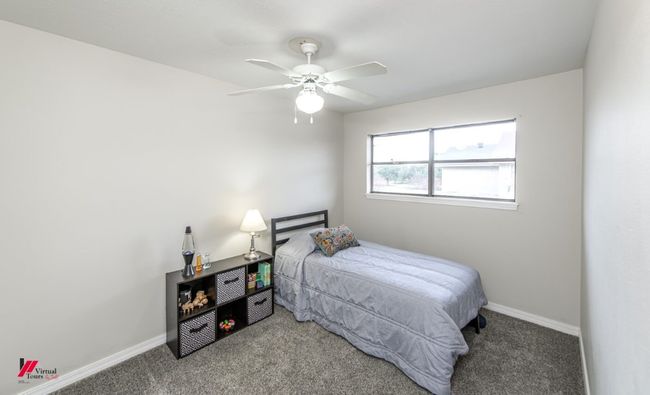 Bedroom featuring baseboards, carpet flooring, and a ceiling fan | Image 24