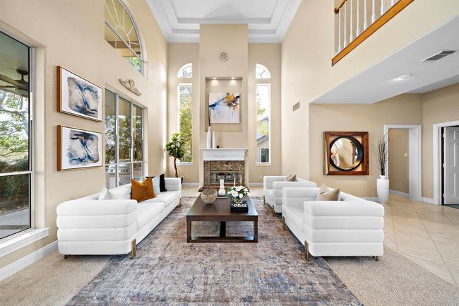 The high ceilings and the cascade of natural light through tall windows highlight the spaciousness of this home. | Image 12
