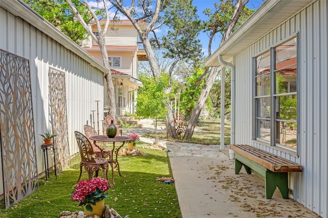 Back on the main level, this quaint Courtyard is right outside the bonus living accommodation. Let's take a peek... | Image 33