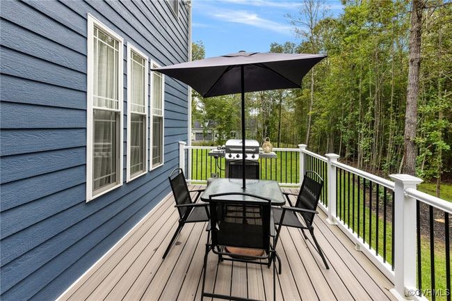 Wooden deck with outdoor dining area and a lawn | Image 34