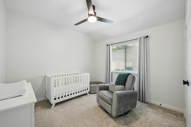 Bedroom with lofted ceiling, light carpet, a nursery area, and ceiling fan | Image 26