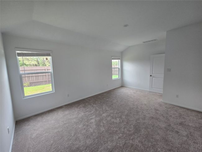 Unfurnished room with carpet and vaulted ceiling | Image 19
