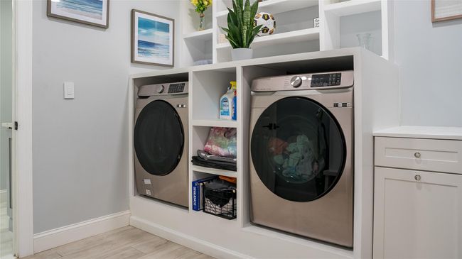 Washroom featuring washer / dryer and light wood finished floors | Image 14