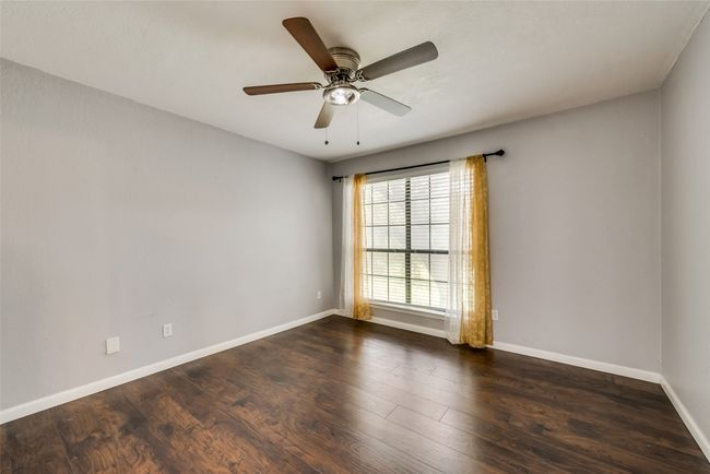 Empty room featuring wood finished floors and a ceiling fan | Image 8