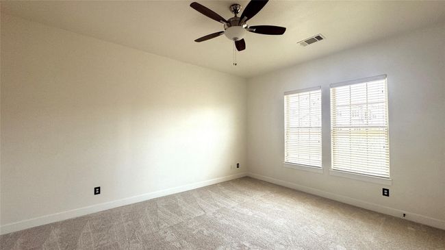 Empty room featuring light colored carpet and a ceiling fan | Image 5