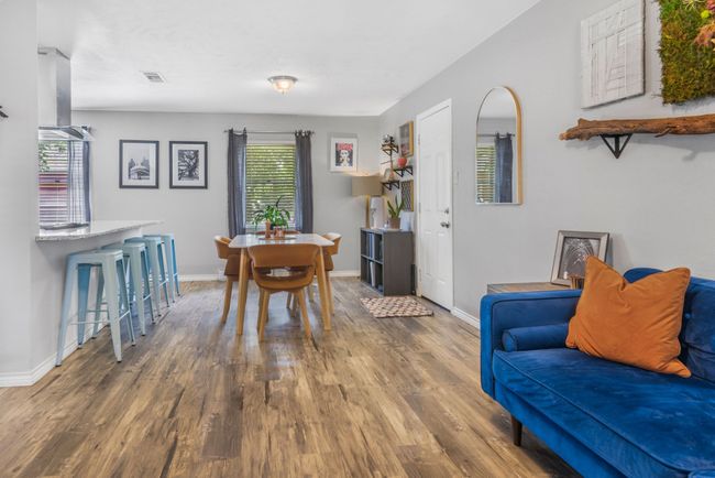 Dining room with LVP wood finished floors and baseboards | Image 5