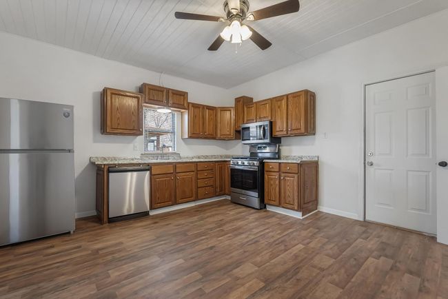 Kitchen with sink, wooden ceiling, appliances with stainless steel finishes, dark hardwood / wood-style flooring, and ceiling fan | Image 14