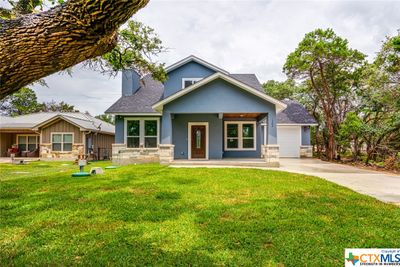 Large front yard with a driveway and easy access to the garage and front door | Image 3