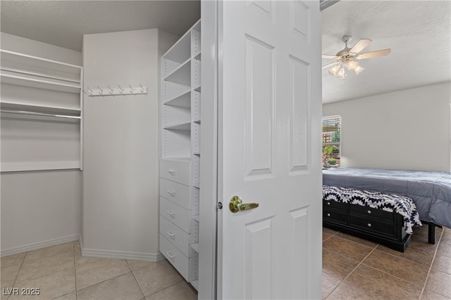 Walk in closet featuring light tile patterned flooring and ceiling fan | Image 27