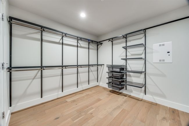 Walk in closet featuring hardwood / wood-style floors | Image 12