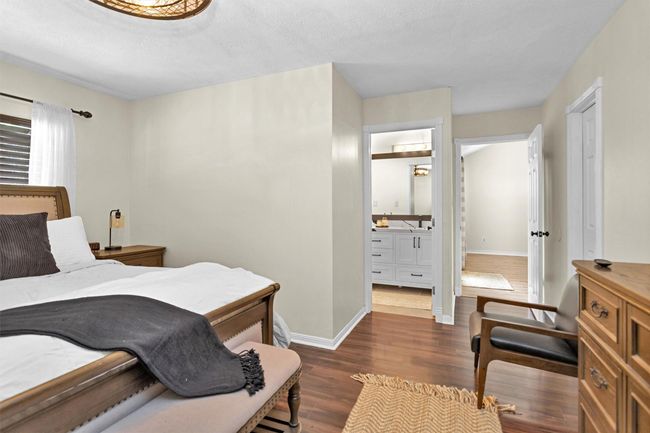 This spacious primary bedroom features a private ensuite bathroom, offering convenience and comfort | Image 16