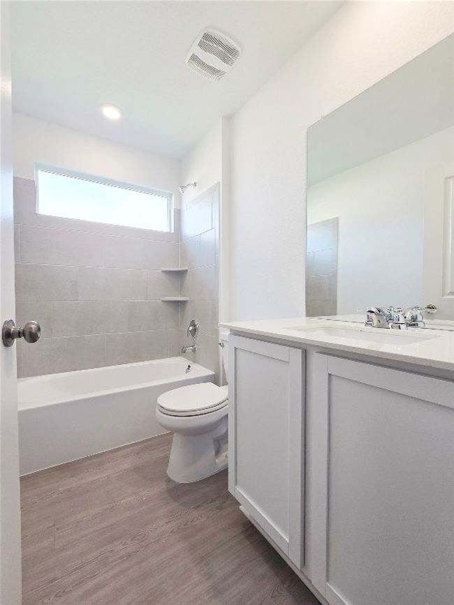 Full bath with vanity, toilet, shower / tub combination, and wood finished floors | Image 33