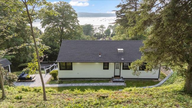 View of front of property featuring entry steps, a front yard, and a shingled roof | Image 39