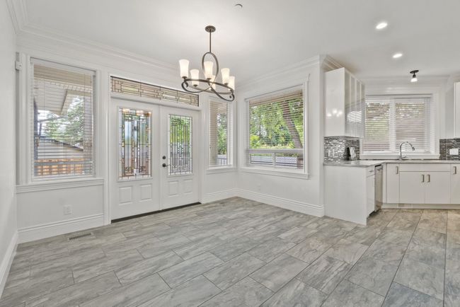Unfurnished dining area with crown molding, healthy amount of natural light, a chandelier, recessed lighting, and french doors | Image 6
