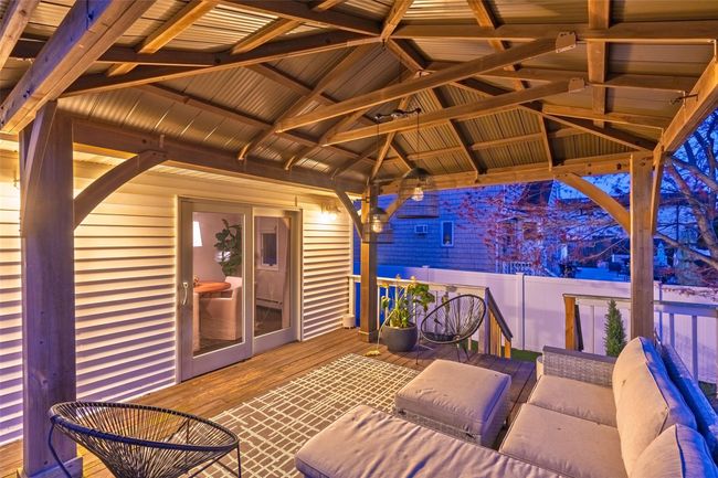 Wooden terrace featuring a gazebo and fence | Image 4