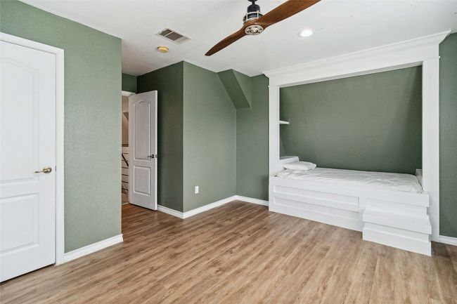 Unfurnished bedroom featuring ceiling fan, baseboards, visible vents, and wood finished floors | Image 24