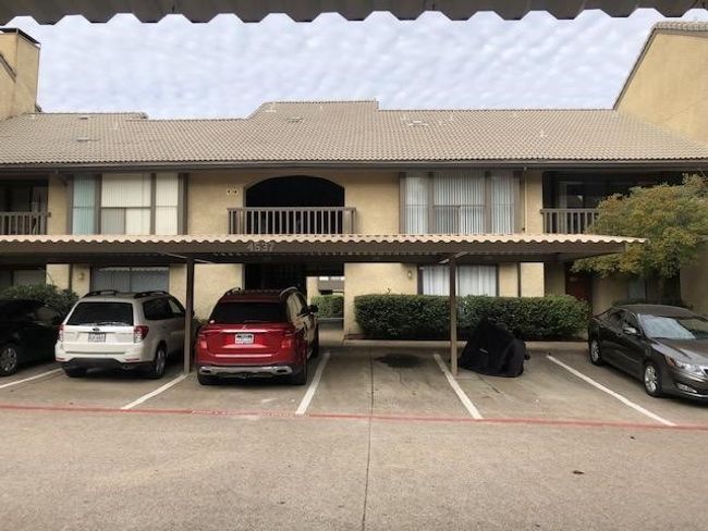 View of building exterior featuring covered parking | Image 16