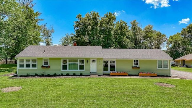 Ranch-style house featuring a front yard, a chimney, entry steps, and roof with shingles | Image 38