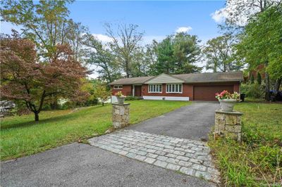 Single story home featuring a front lawn and a garage | Image 2