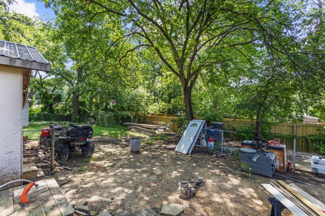 Fenced backyard with view of wooded area | Image 22