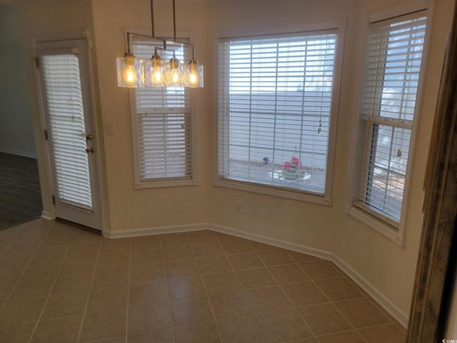 Unfurnished dining area featuring baseboards and light tile patterned floors | Image 30