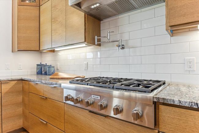 High end appliances and pot filler over cooktop | Image 9