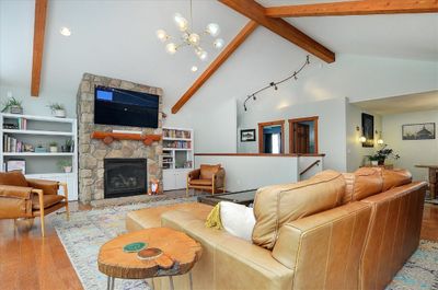 Vaulted ceiling with gas fireplace in the main living area. | Image 3