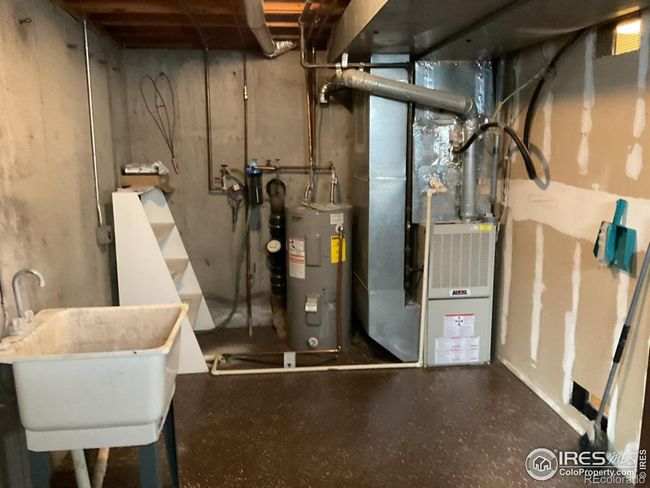 Utility Room in Basement has Utility Sink and Hook Ups for Washer and Dryer Plus Storage Shelving | Image 21