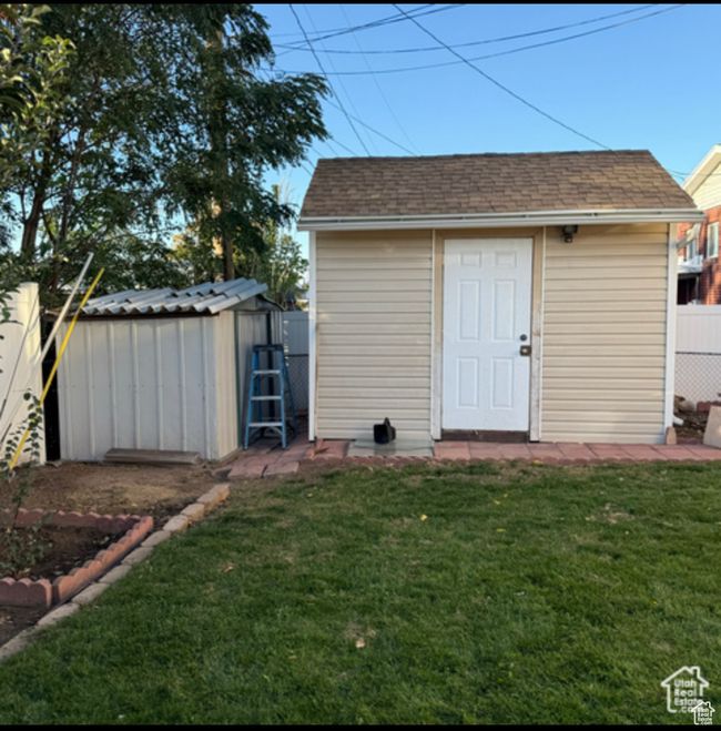 View of shed with a fenced backyard | Image 22