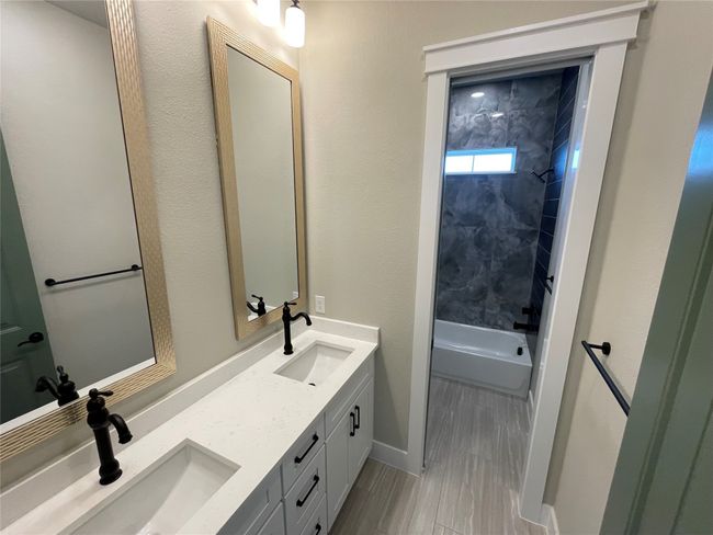 Full bathroom featuring double vanity and shower / bathtub combination | Image 32