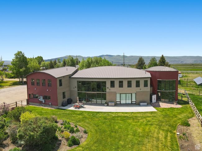 Back of property featuring stucco siding, a patio, metal roof, and a mountain view | Image 42