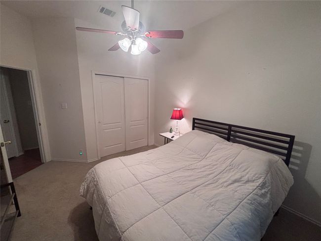 Carpeted bedroom with a closet and ceiling fan | Image 7