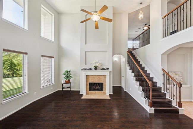 A view of the living room and stairs leading to the second floor tastefully completed with iron wrought balusters. | Image 16