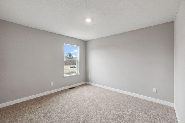 Spacious secondary bedroom with natural light. Model photos. Options and colors will vary. | Image 30