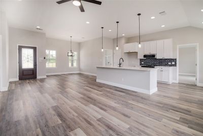 Featuring a stunning open floor plan with soaring ceilings, recessed lighting, and stylish contemporary fixtures. | Image 2