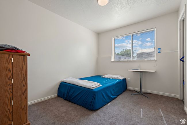 Bedroom featuring carpet and a textured ceiling | Image 28