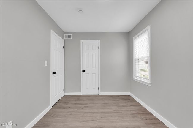 Unfurnished bedroom with visible vents, a closet, light wood-style flooring, and baseboards | Image 15