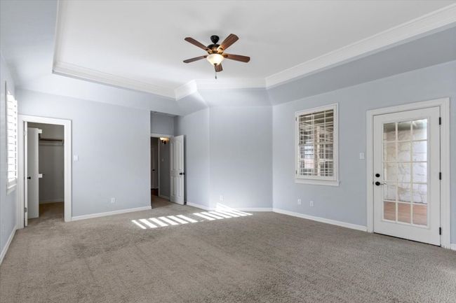 From this angle, you can appreciate the spaciousness of the primary suite, which also features a door leading to the back patio deck. | Image 20