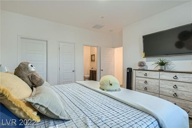 Bedroom featuring visible vents and connected bathroom | Image 9