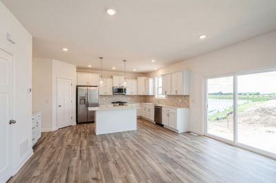 (Photo of inventory home, actual features may vary) The kitchen overlooks the open concept dining and living area, creating the perfect environment for any family to thrive | Image 1