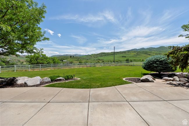 View of yard with a mountain view, a patio area, and a view of rural / pastoral area | Image 79