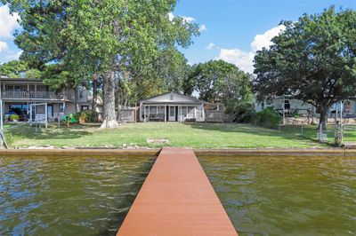 Dock area with a yard and a water view | Image 1