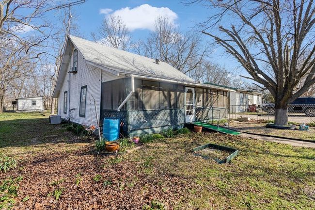 View of side of property with central AC and a sunroom | Image 5