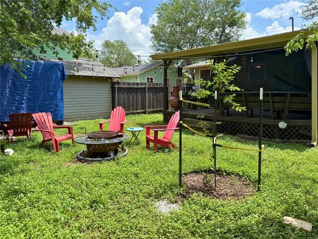 View of yard featuring a fire pit and a deck | Image 16