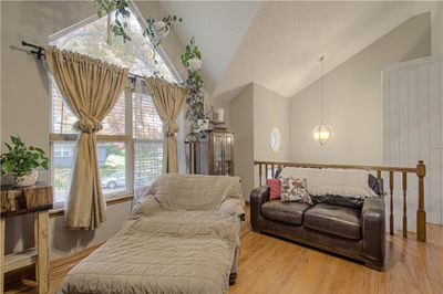 Sitting room with light hardwood / wood-style floors and high vaulted ceiling | Image 3