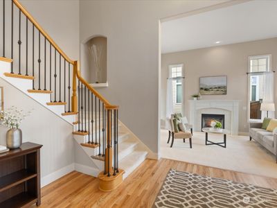 Soaring two story entry with hardwood floors and open staircase. | Image 3