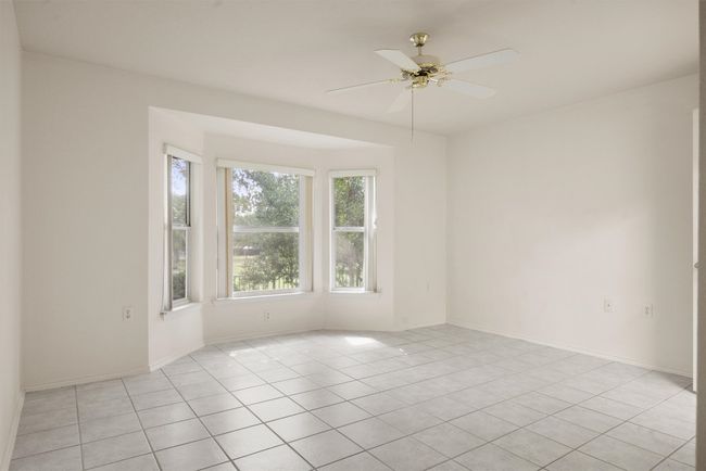 Empty room featuring ceiling fan and light tile patterned flooring | Image 17