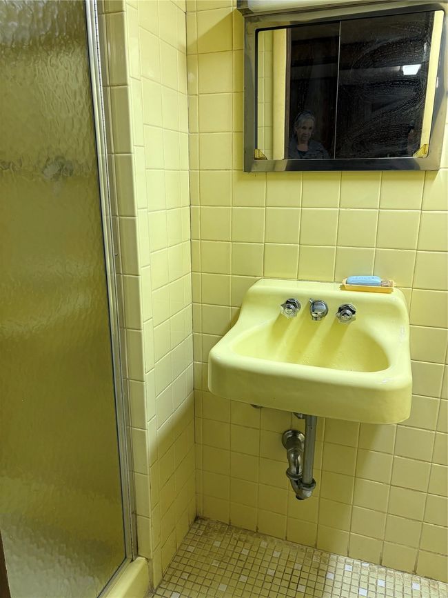 Full bath featuring backsplash, a sink, a stall shower, and tile walls | Image 13