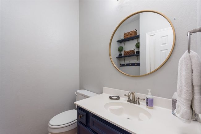 Bathroom featuring toilet and vanity | Image 12