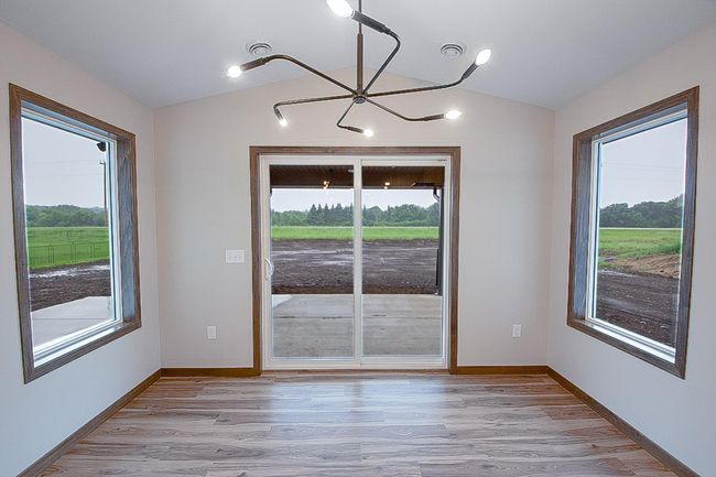 Dining Room walks out to covered rear porch and additional concrete patio | Image 6